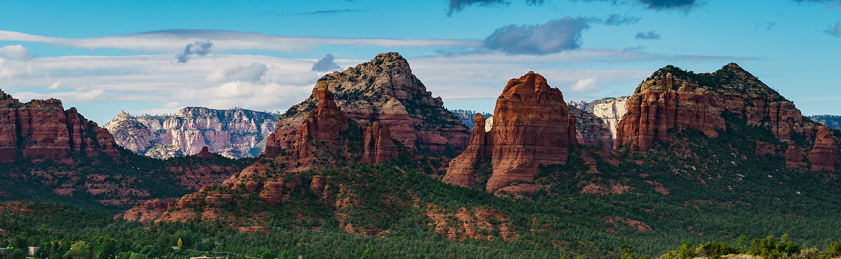 Red rock formations under a cloudy sky.
